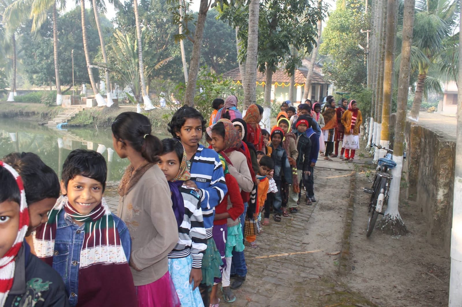 Children standing in line during Ashram service work