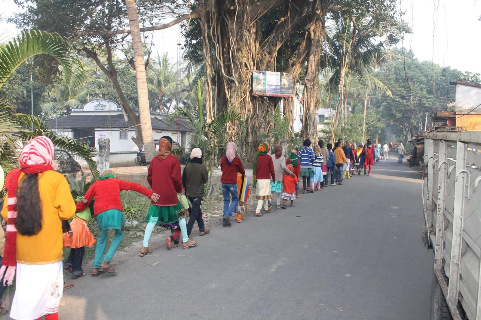 Local residents lined along the road for service activity